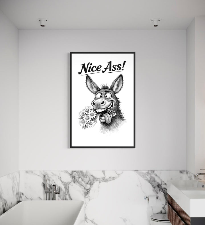 A black and white canvas print of a funny donkey with the text Nice Ass! hangs in a bathroom.