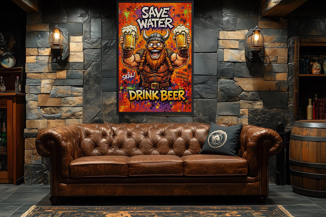 A colorful Viking canvas print with the text Save Water Drink Beer hangs above a leather sofa.