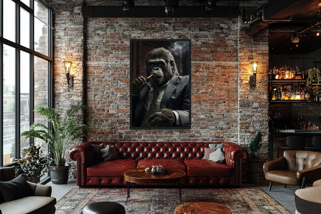 Framed canvas wall art of a gorilla in a suit smoking a cigar, hung in a brick-walled lounge.