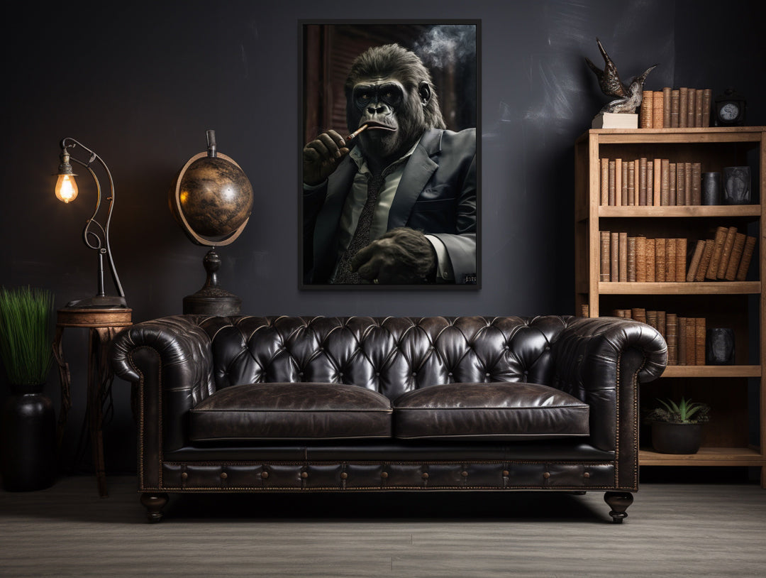 Framed canvas wall art of a gorilla in a suit smoking a cigar, hung above a leather sofa.