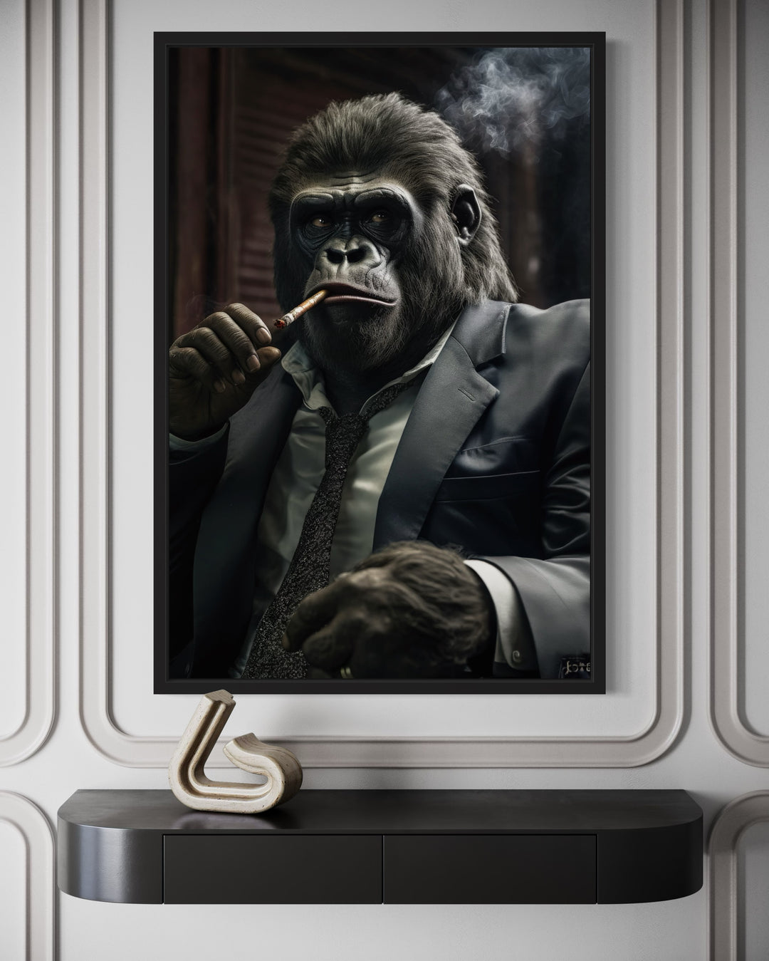 Framed canvas wall art of a gorilla in a suit smoking a cigar, mounted above a black console table.