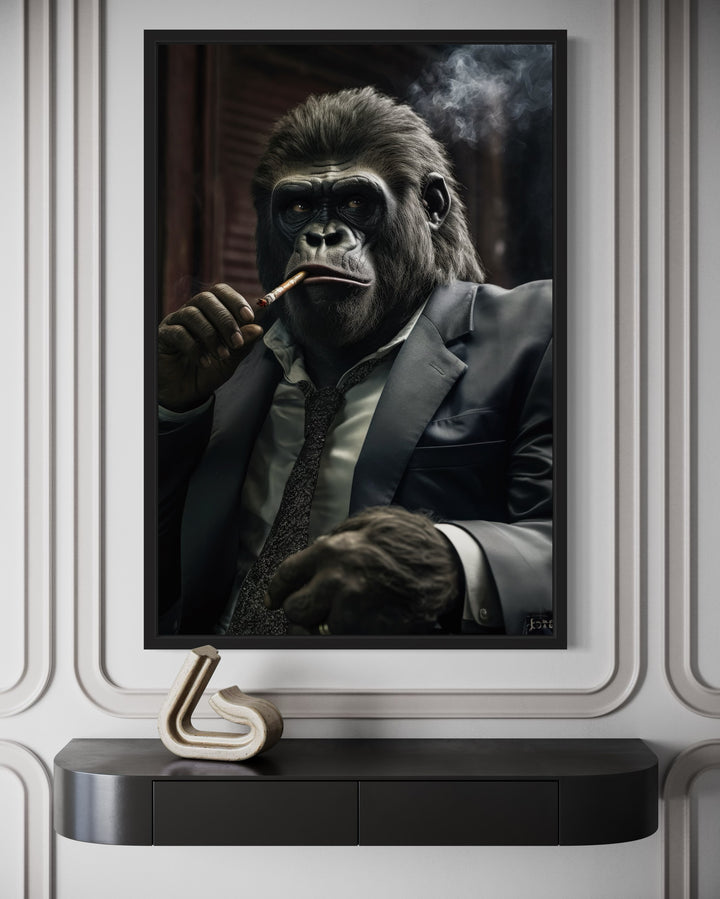 Framed canvas wall art of a gorilla in a suit smoking a cigar, mounted above a black console table.