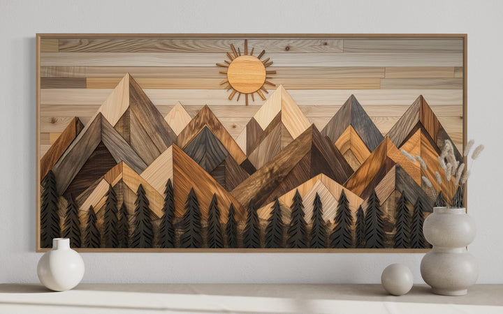 Geometric wood mountain and pine trees forest canvas wall art with a rising sun in a wood frame.
