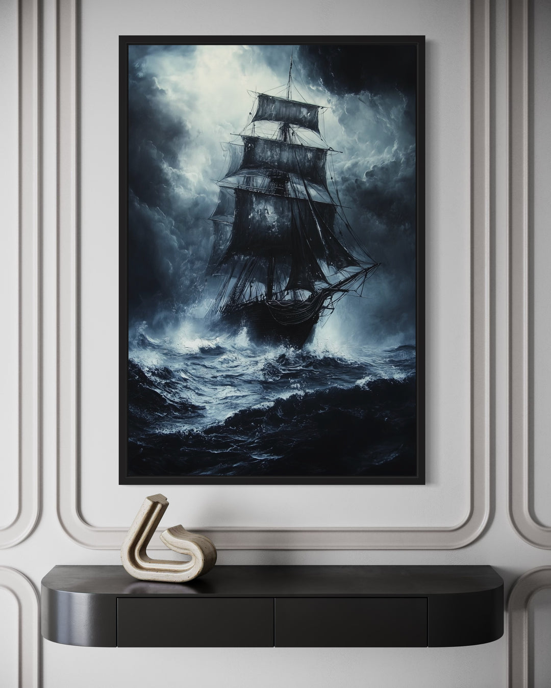 Gothic framed canvas wall art of a ghost pirate ship on a stormy, moonlit ocean above a black desk.
