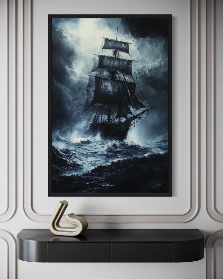 Gothic framed canvas wall art of a ghost pirate ship on a stormy, moonlit ocean above a black desk.