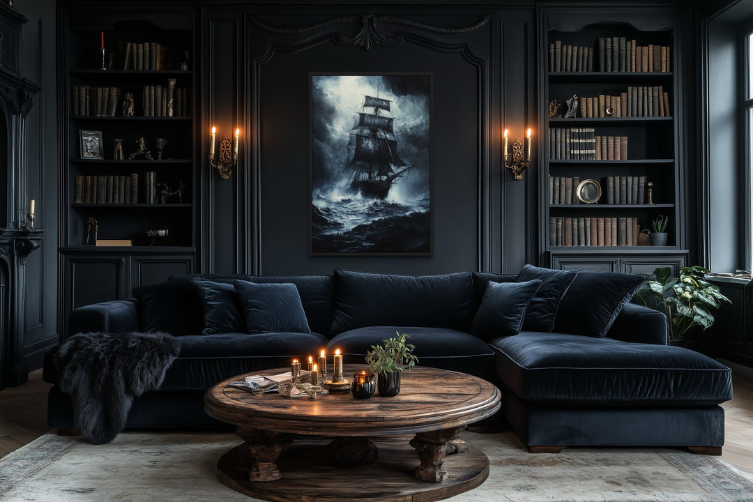Gothic framed canvas wall art of a ghost pirate ship in a stormy ocean above a dark velvet sofa.