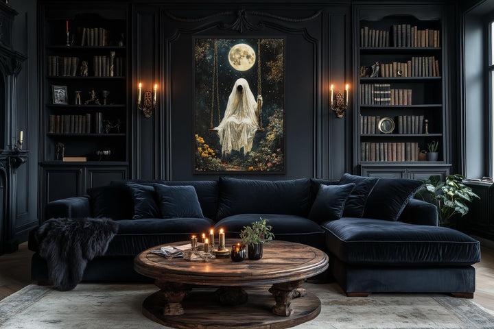 Gothic wall art of a ghost on a swing under a full moon, hung in a dark, moody living room.