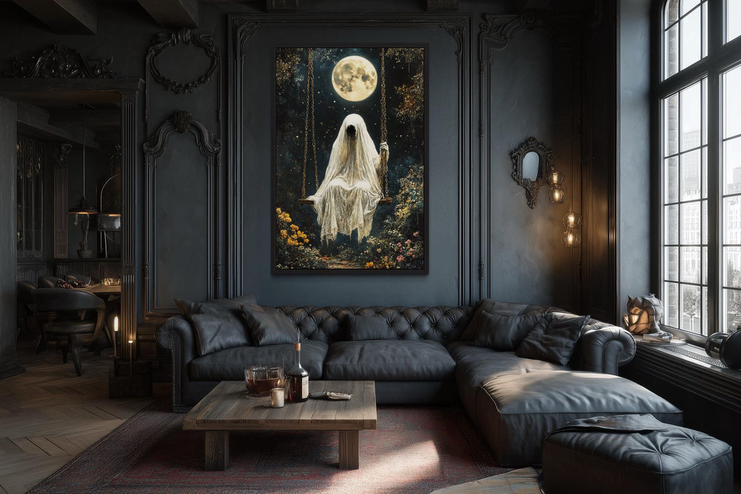 Gothic wall art of a ghost on a swing under a full moon in a dark, moody living room.