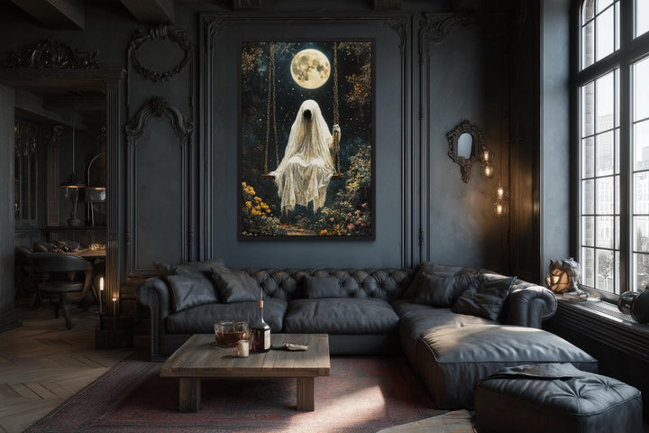 Gothic wall art of a ghost on a swing under a full moon in a dark, moody living room.