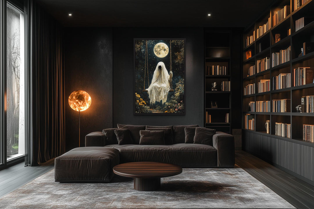 Ghost on Swing Under Full Moon Gothic Wall Art hanging in a dark, modern living room with a library.
