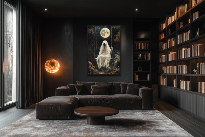 Ghost on Swing Under Full Moon Gothic Wall Art hanging in a dark, modern living room with a library.