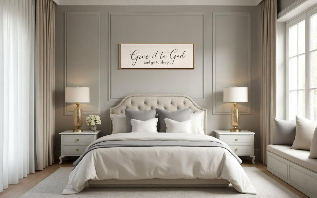 Give it to God and Go to Sleep long horizontal canvas sign hanging above a neutral-toned bed.