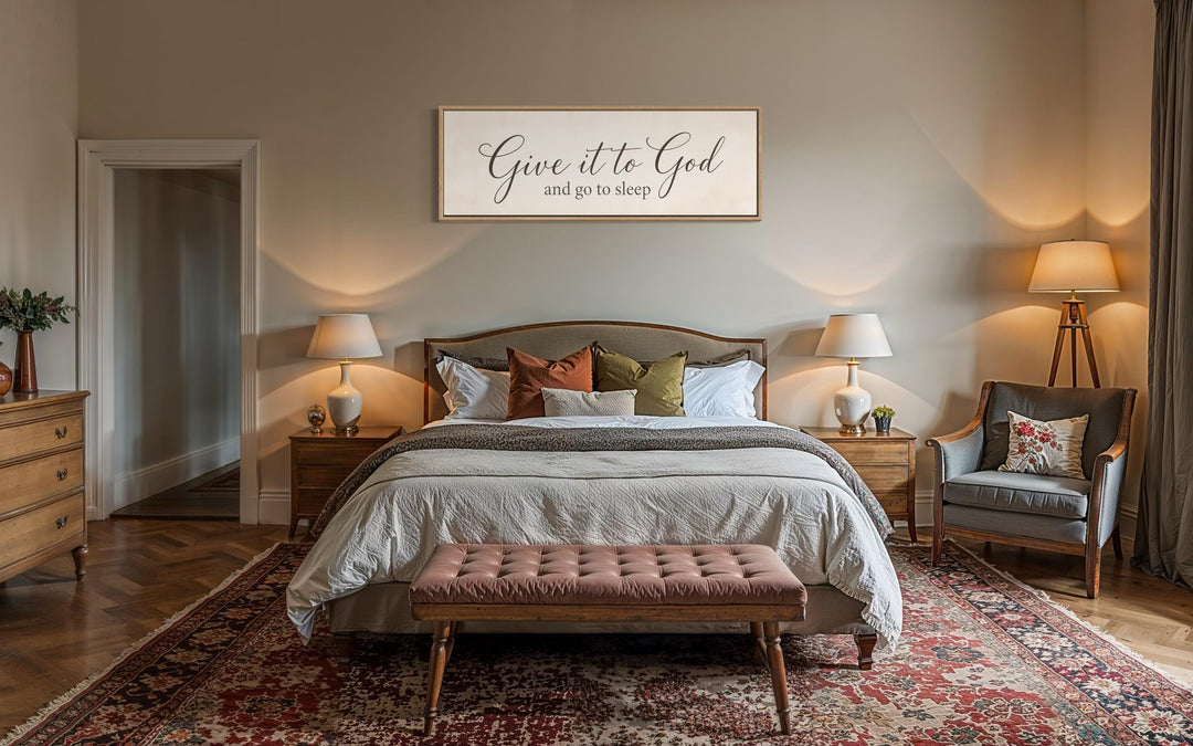Give it to God and Go to Sleep long horizontal canvas sign hanging above a bed.