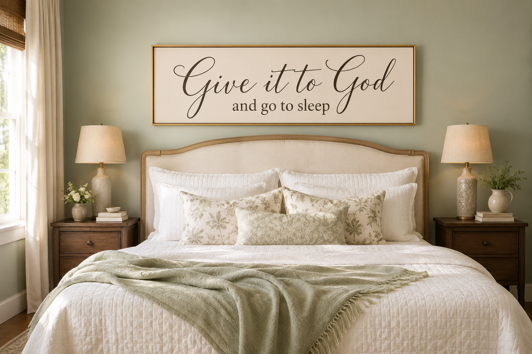 Give it to God and Go to Sleep long horizontal canvas sign hanging above a bed in a neutral bedroom.
