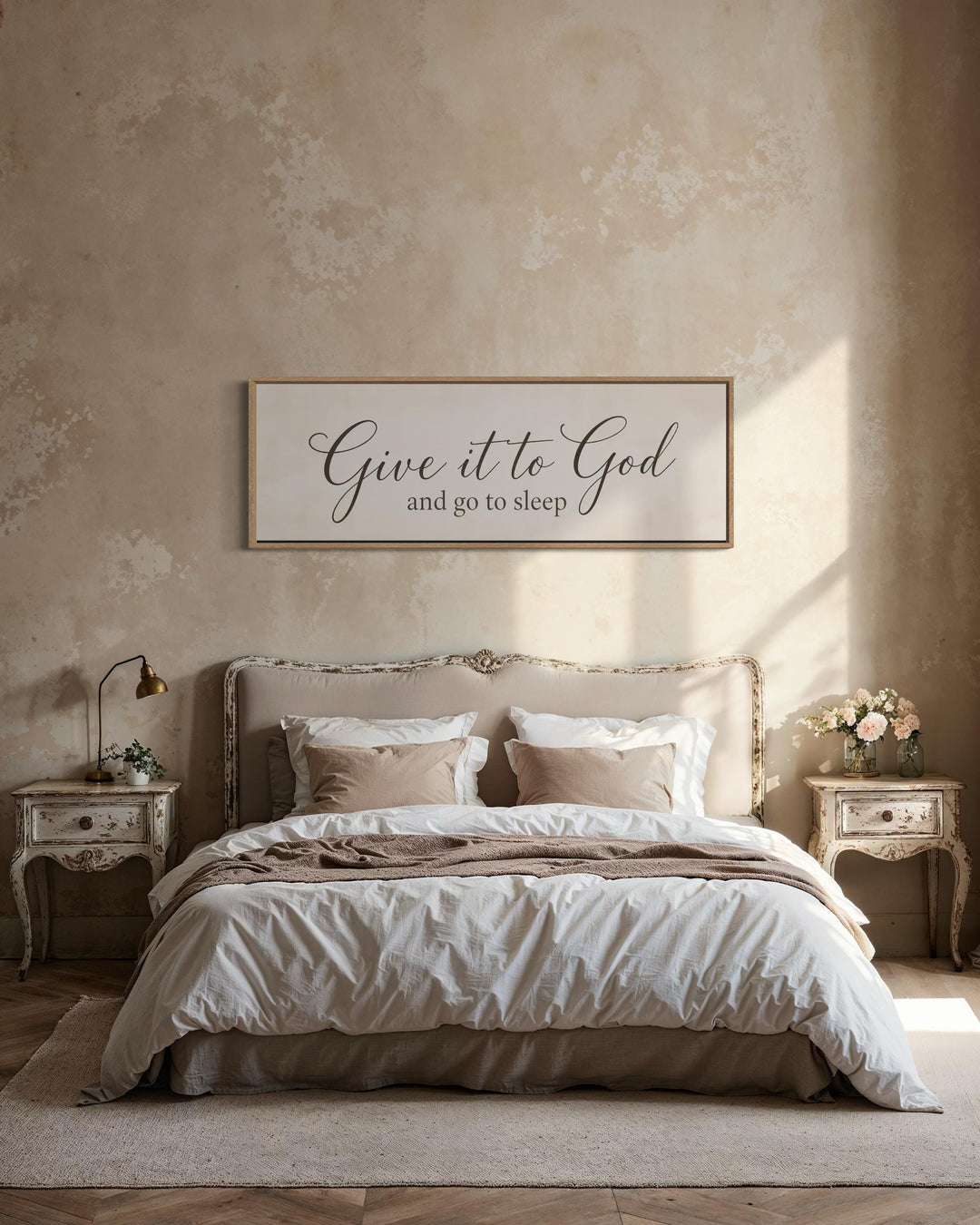 Give it to God and go to sleep long horizontal canvas sign above a bed in a neutral bedroom.