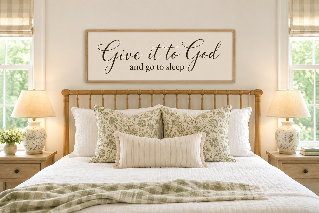 Give it to God and Go to Sleep long horizontal sign in a neutral bedroom above a wooden headboard.