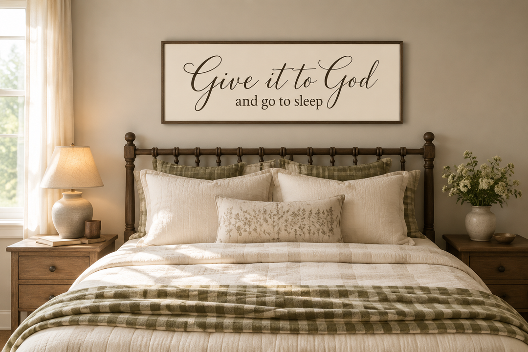 Give it to God and Go to Sleep long horizontal sign in a wooden frame hanging above a bed.