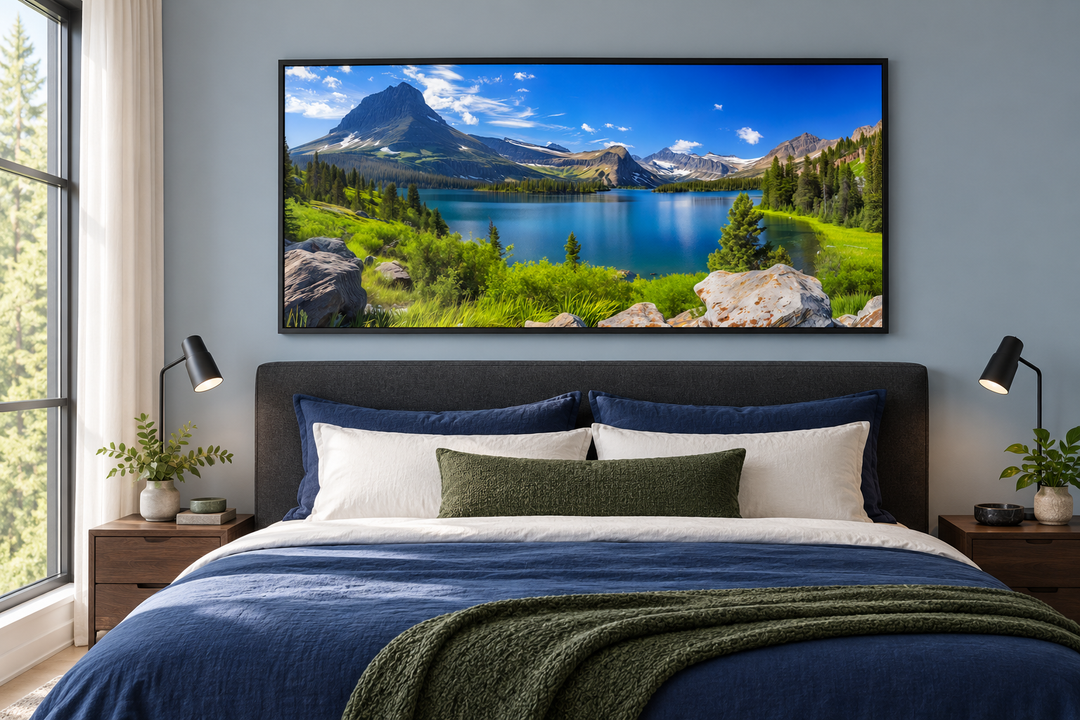 Framed canvas print of Glacier National Park landscape hanging above a bed in a modern bedroom.