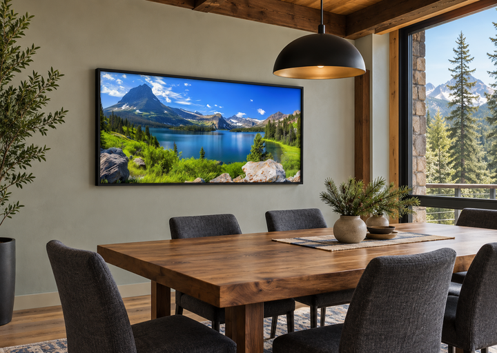 Framed canvas print of a Glacier National Park landscape hanging in a rustic dining room.