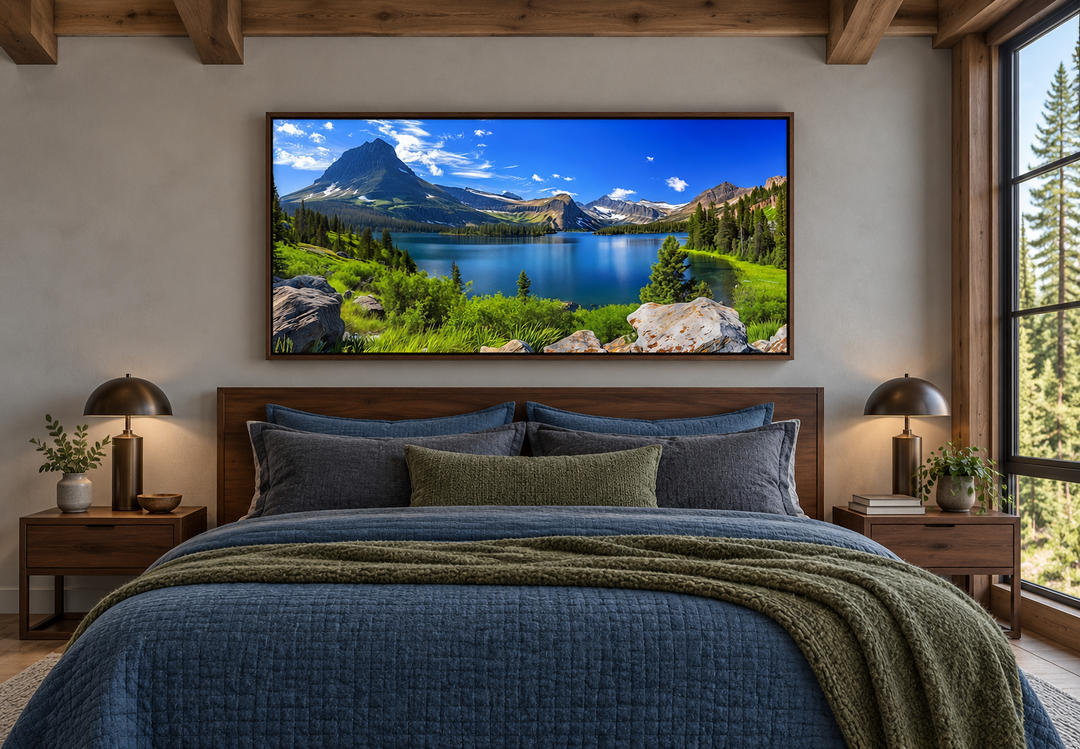 Framed canvas print of Glacier National Park landscape hanging above a bed in a rustic bedroom.