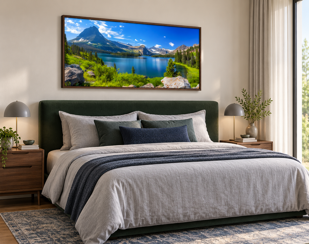 Framed canvas print of Glacier National Park landscape hanging above a bed in a modern bedroom.