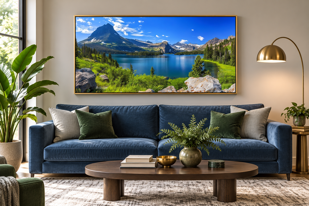 Framed canvas print of Glacier National Park landscape above a blue sofa in a modern living room.