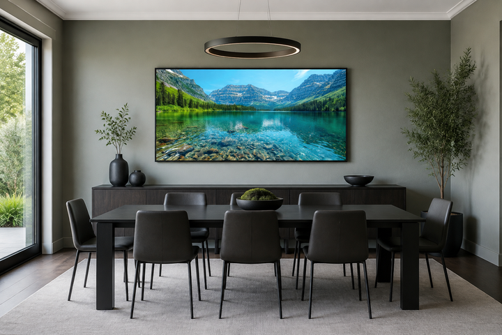 Framed canvas wall art of Glacier National Park landscape above a dining table in a modern room.