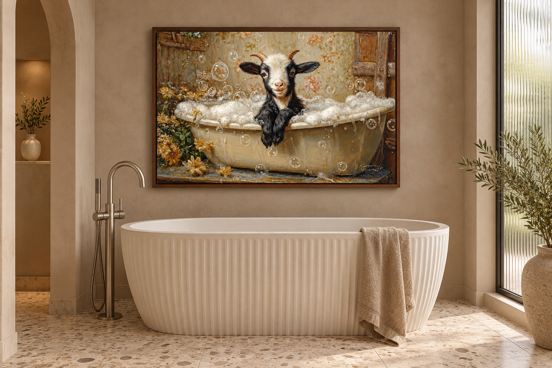 Goat in a Bathtub Framed Canvas Wall Art hanging in a modern bathroom above a white fluted tub.