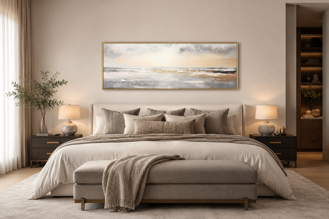 Gold and silver abstract beach sunset minimalist panoramic wall art hanging over a bed.