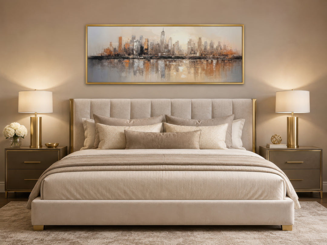 Gold and silver abstract New York City skyline horizontal wall art hanging above a bed.