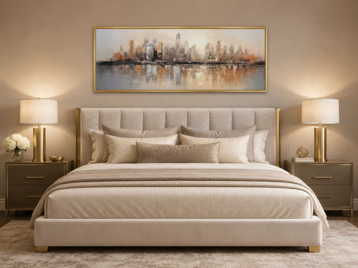 Gold and silver abstract New York City skyline horizontal wall art hanging above a bed.