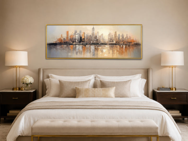 Gold and silver abstract New York City skyline horizontal wall art hanging above a bed.