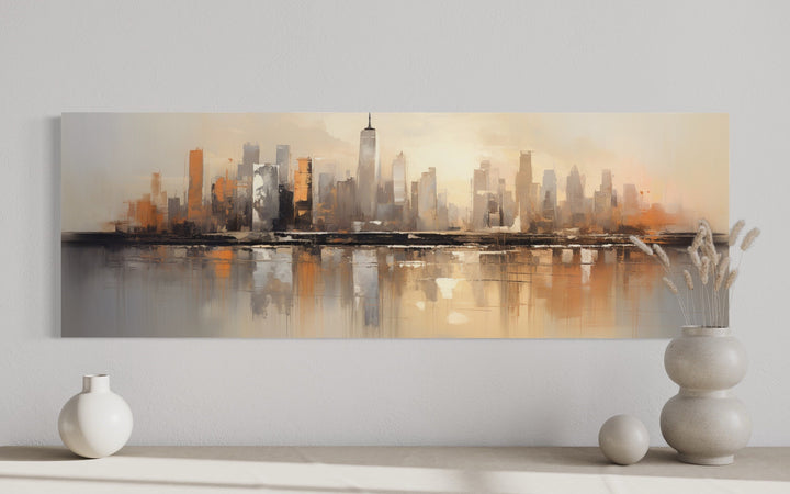 Gold and silver abstract New York City skyline horizontal wall art displayed above a console table.