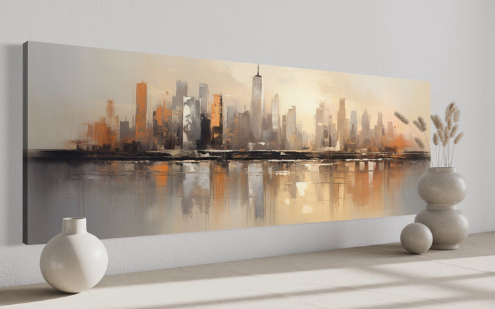 Panoramic gold and silver abstract painting of the New York City skyline on a white wall.