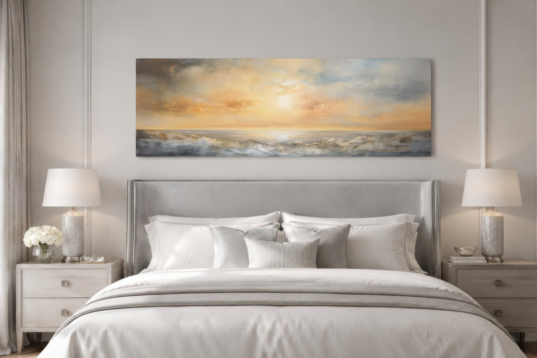 Gold and silver abstract ocean sunset panoramic canvas art displayed over a bed in a bedroom.