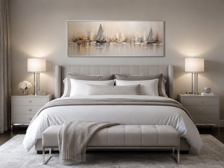 Gold and silver abstract sailboats horizontal wall art hanging above a bed in a neutral bedroom.
