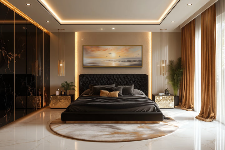 Narrow horizontal wall art of a gold and silver beach sunset with birds above a black bed.