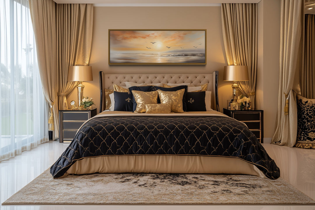 Narrow horizontal wall art of a gold and silver beach sunset with birds above a bed.