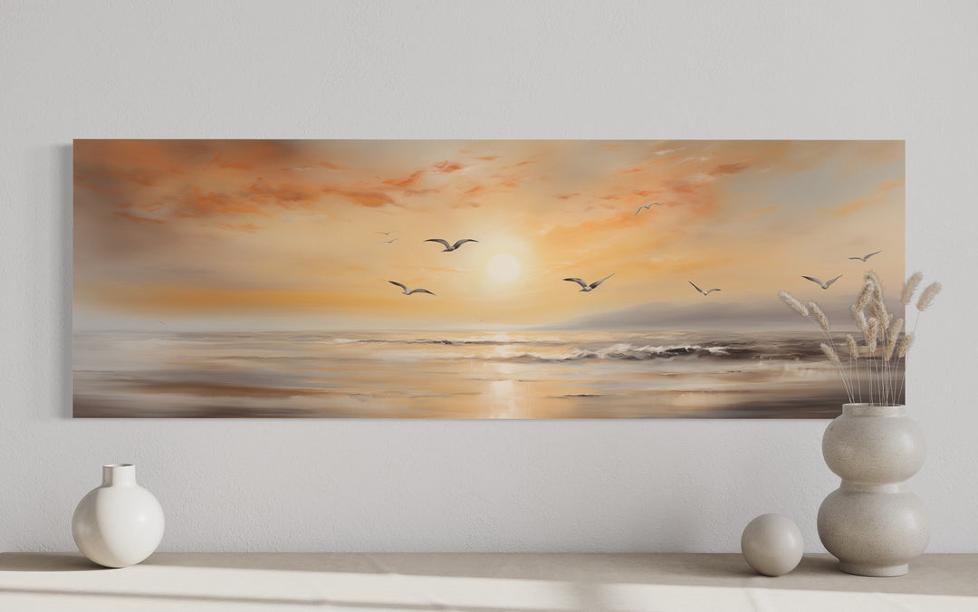 Narrow horizontal wall art of a gold and silver beach sunset seascape with birds flying.