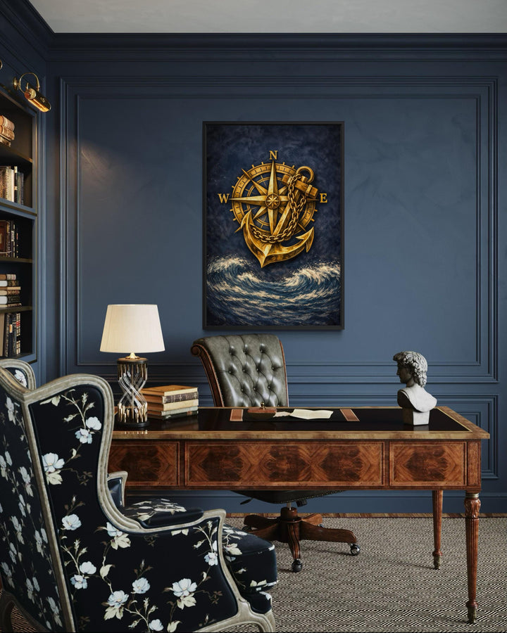Nautical wall art featuring a gold compass and anchor over navy blue ocean waves in a home office.