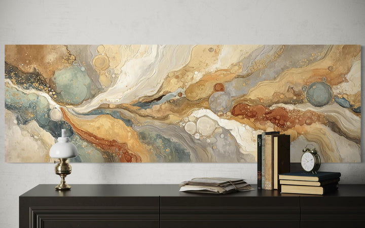 Gold and grey abstract long horizontal marble canvas wall art displayed above a dark wood console.