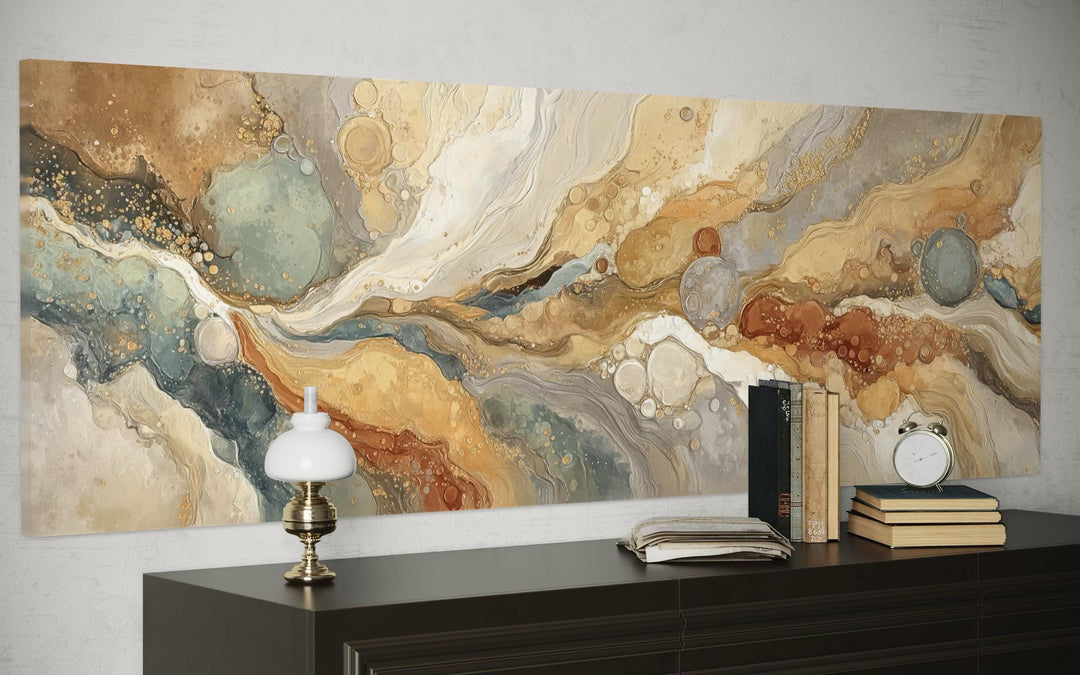 Gold and grey abstract long horizontal marble canvas wall art displayed above a dark wood sideboard.