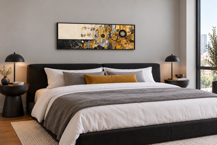 Gold, silver, and black floral abstract wall art in a black frame above a modern bed.