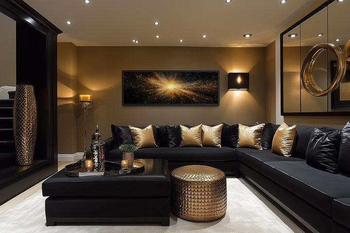 Horizontal black and gold starburst canvas wall art centered above a modern black sectional sofa.