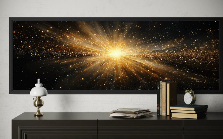 A wide horizontal canvas print of a radiant gold starburst explosion on a black background.