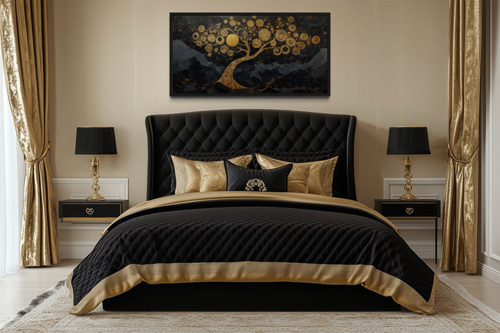 Gold Tree of Life wall art on black background hanging above a black and gold tufted bed.