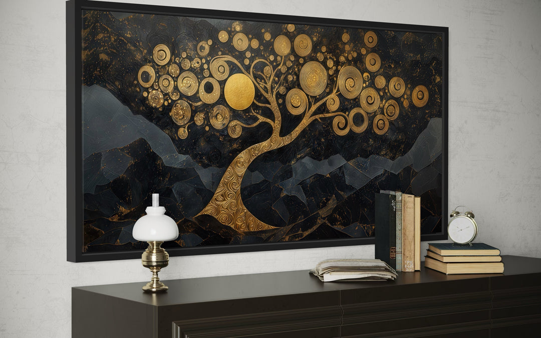 Gold Tree of Life wall art with swirling branches on a black background above a dark wood dresser.