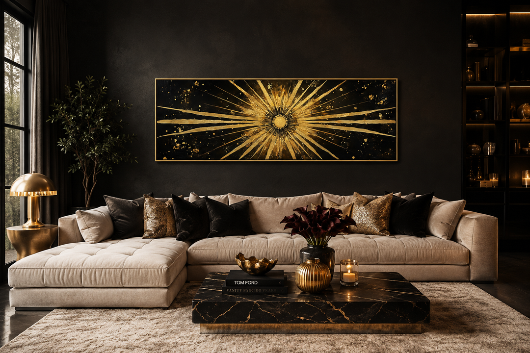 Long horizontal black and gold canvas art with a radiating sunburst above a modern velvet sofa.