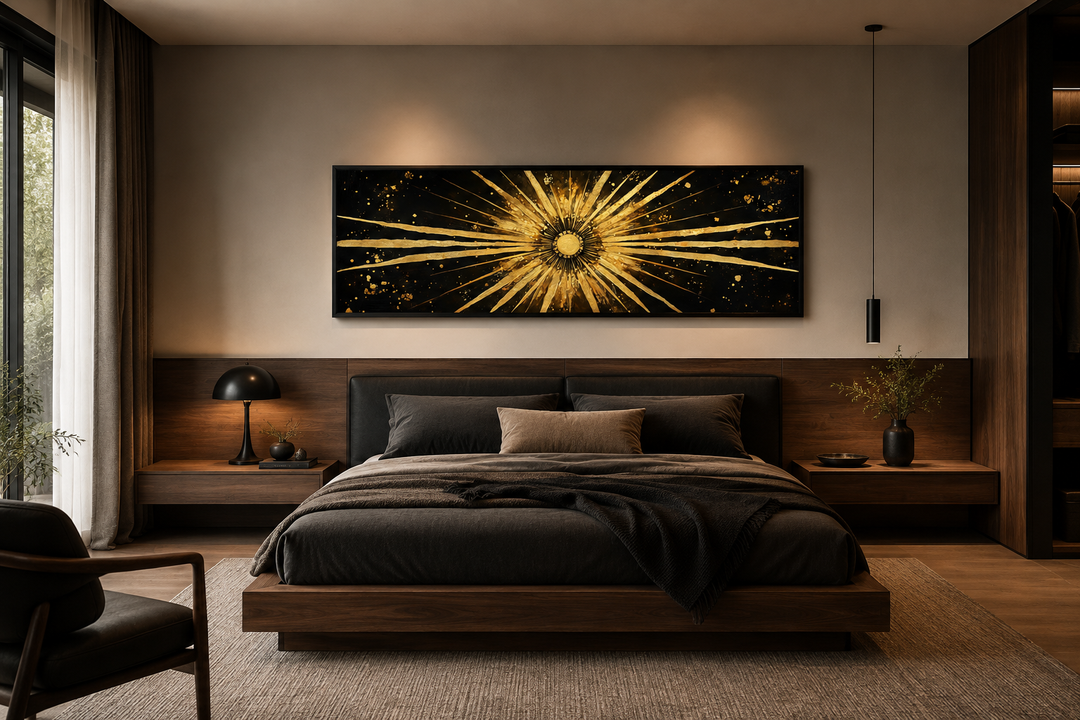 Long horizontal black and gold sunburst abstract painting hanging above a bed in a modern bedroom.