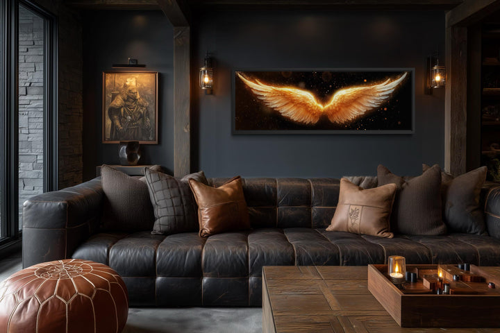 Horizontal canvas print of glowing golden angel wings on a black background in a dark luxury room.